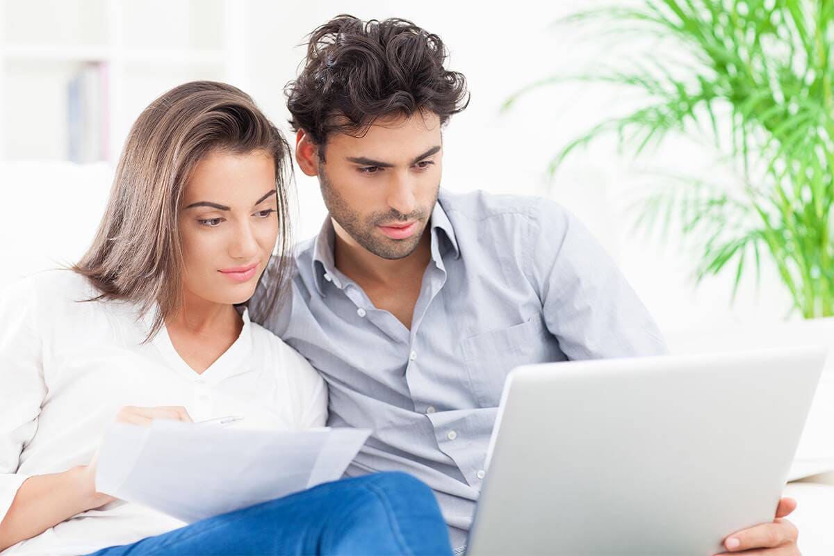Couple in front of laptop doing home buying research