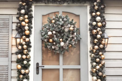 House christmas decorations in gold and silver colors. !hristmas wreath on the door