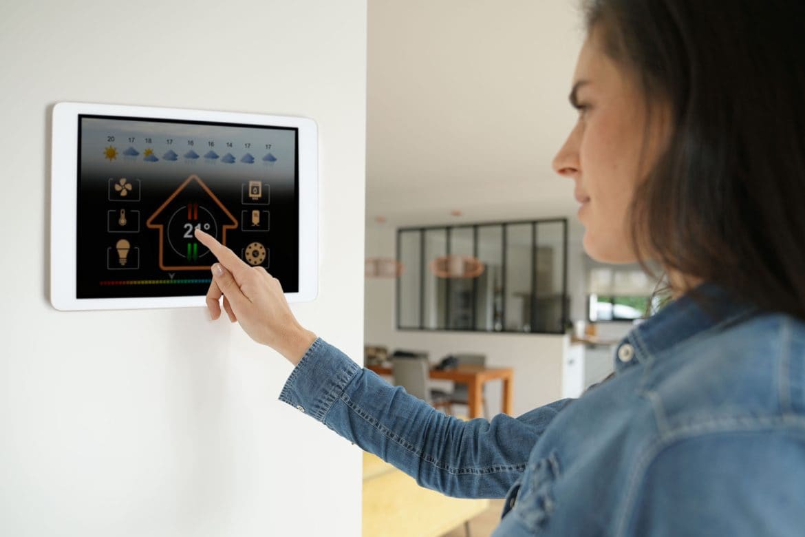 Woman using smart wall home control system