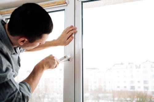 The worker installing and checking window in the house