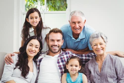 Portrait of happy family with grandparents at home