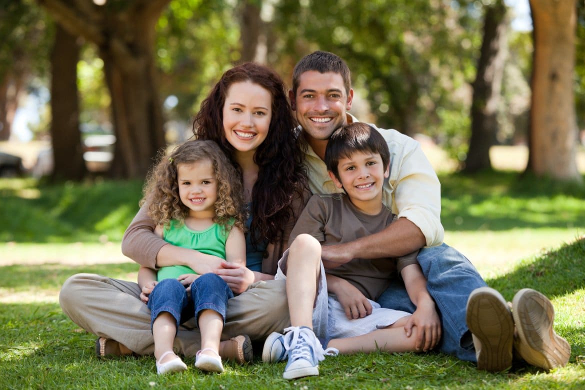 Radiant family sitting in the garden
