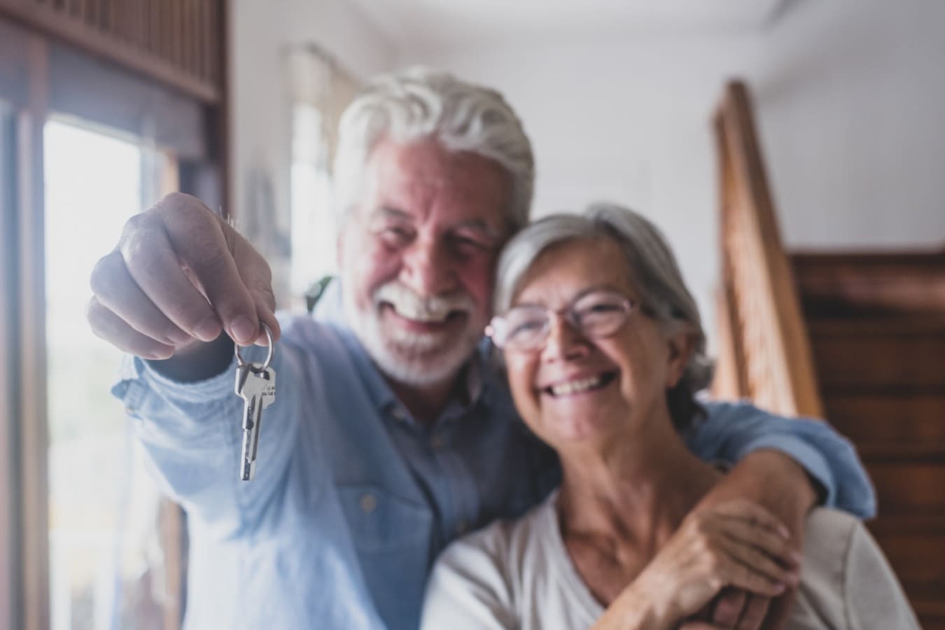 Old couple with home keys