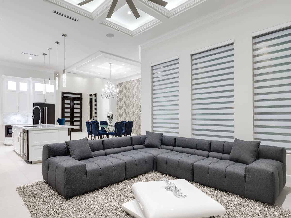 Living room interior with grey coaches, and large fan